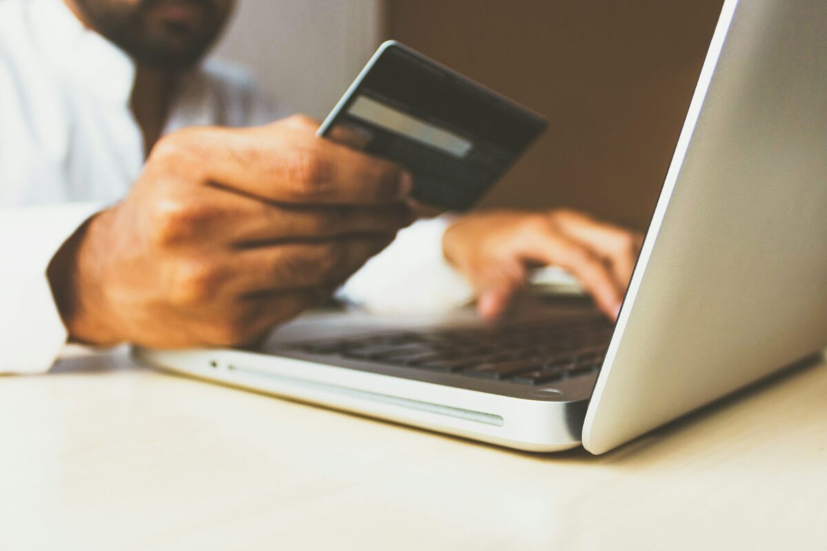 Person booking parking online with a credit card.