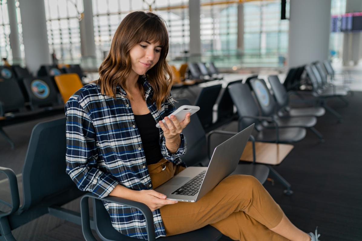 Businesswoman working while waiting in airport terminal.